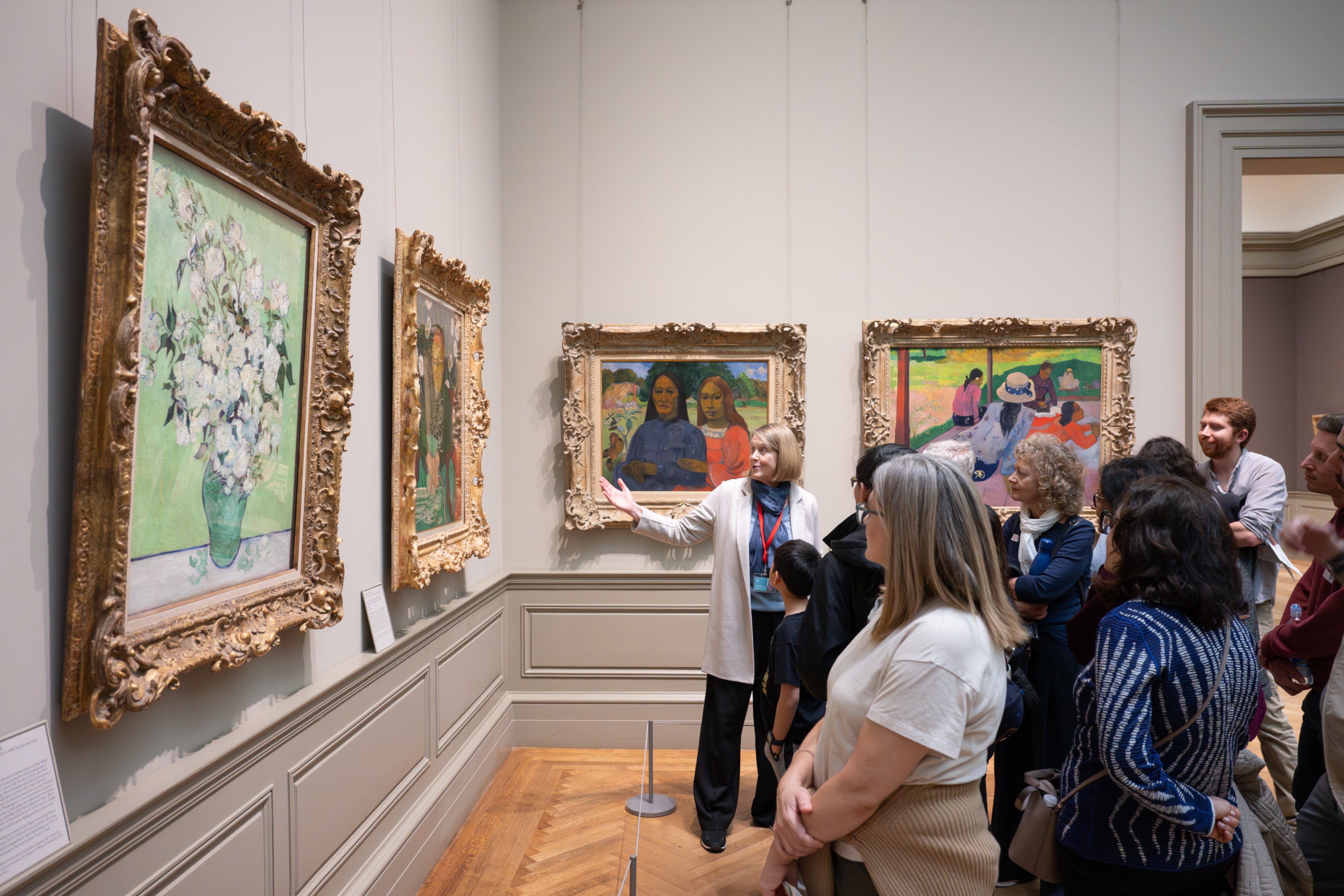 A group of visitors listening to a speaker, engaged in an Expert Talk. 